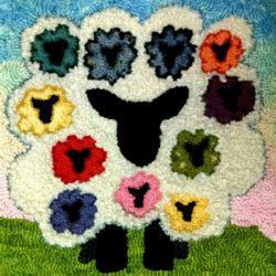 A large sheep with 11 smaller sheep hooked in its curls.