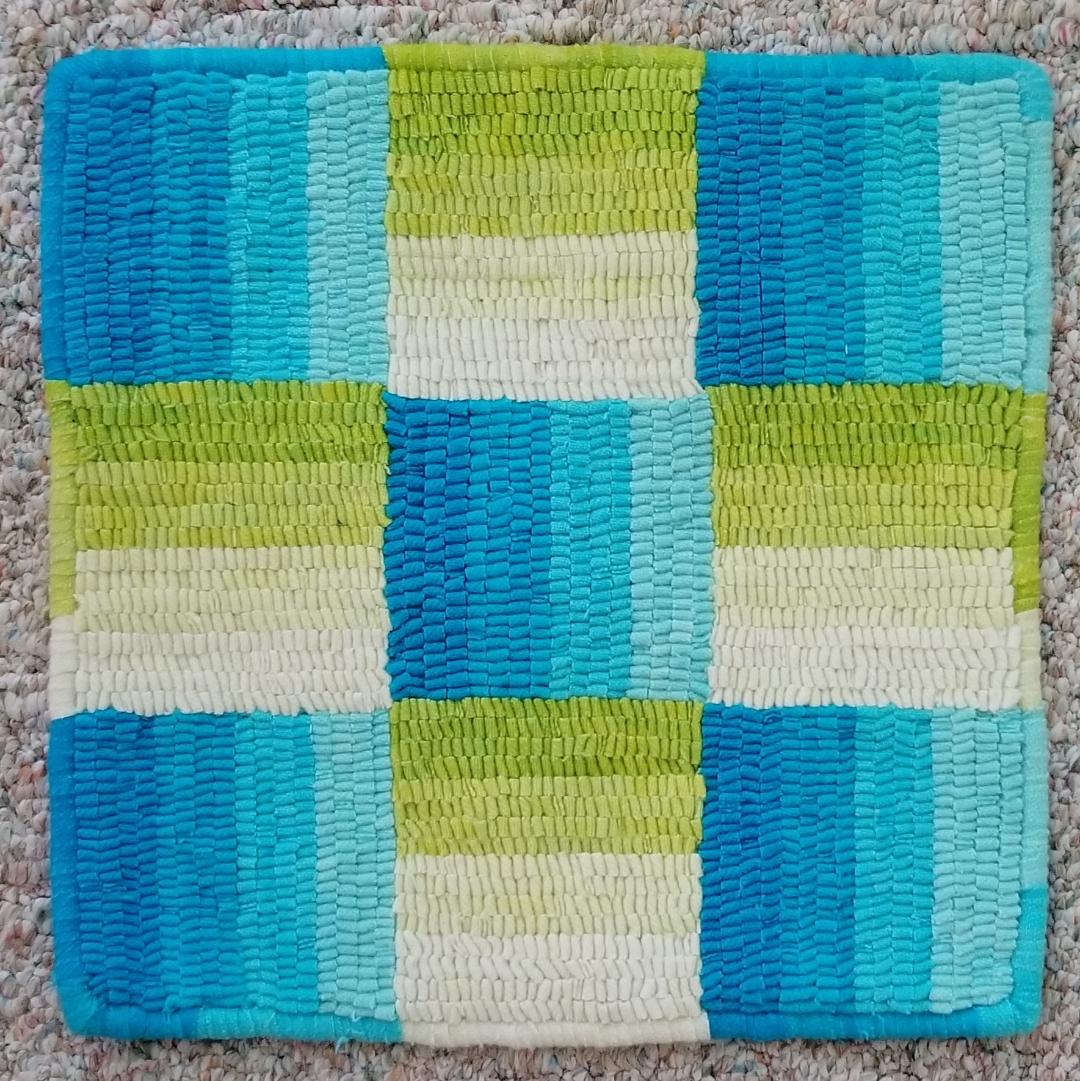 DeWormer II - Hooked by Kimberly Hirt in Summer colors of bright blues and greens.