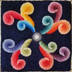 Rainbow colored scrolls on a 12 inch square pattern.